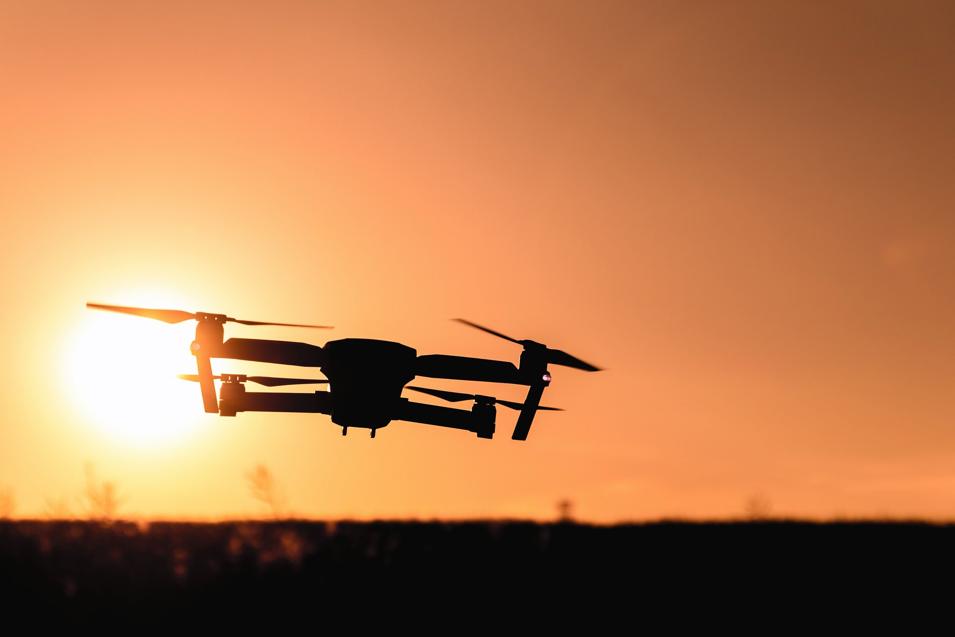 Drone Silhouette with Camera Flying in the Sunset Light